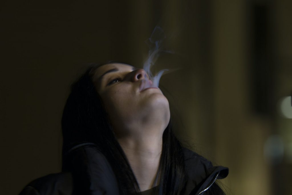 Woman blowing smoke