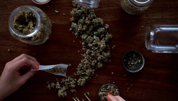 Person holding paper on kush